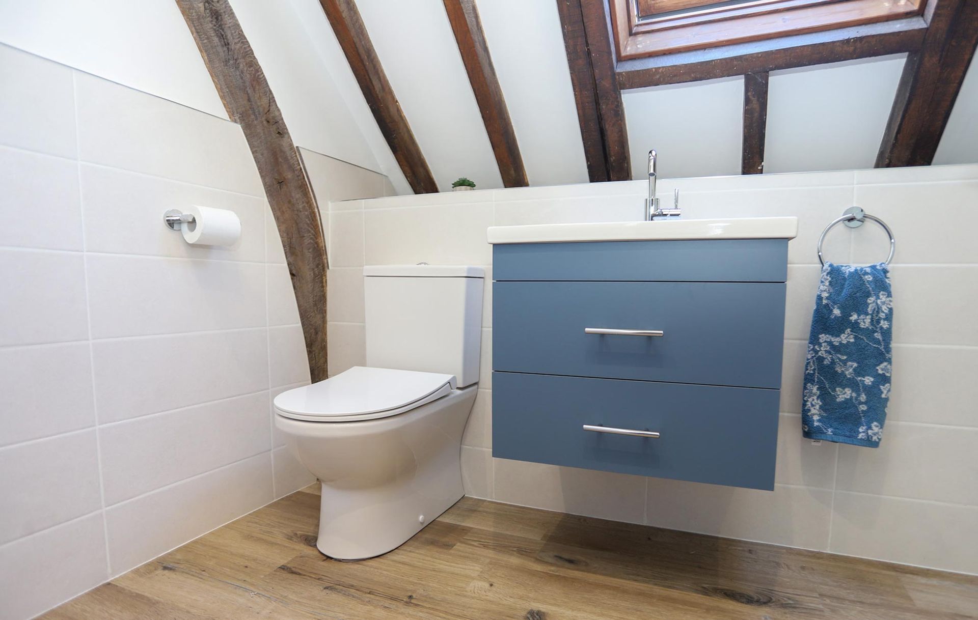A bathroom with a toilet a sink and a window