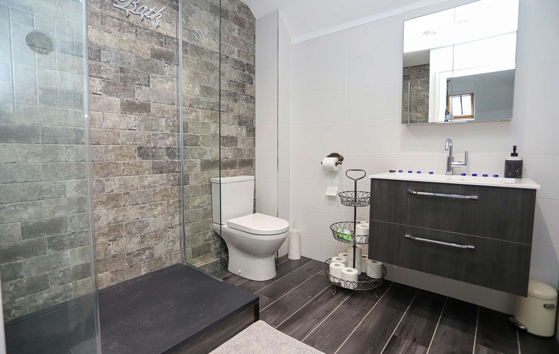 A bathroom with a toilet a sink and a mirror