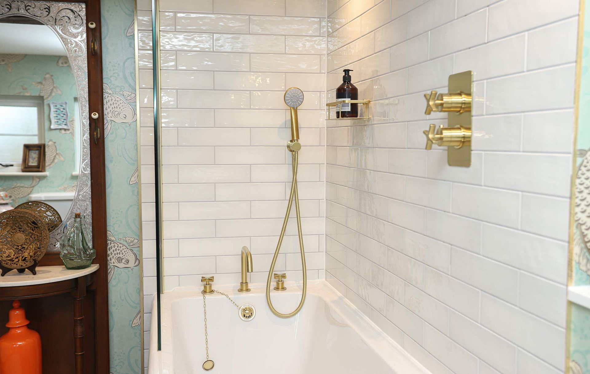 A bathroom with white tiles and a bathtub