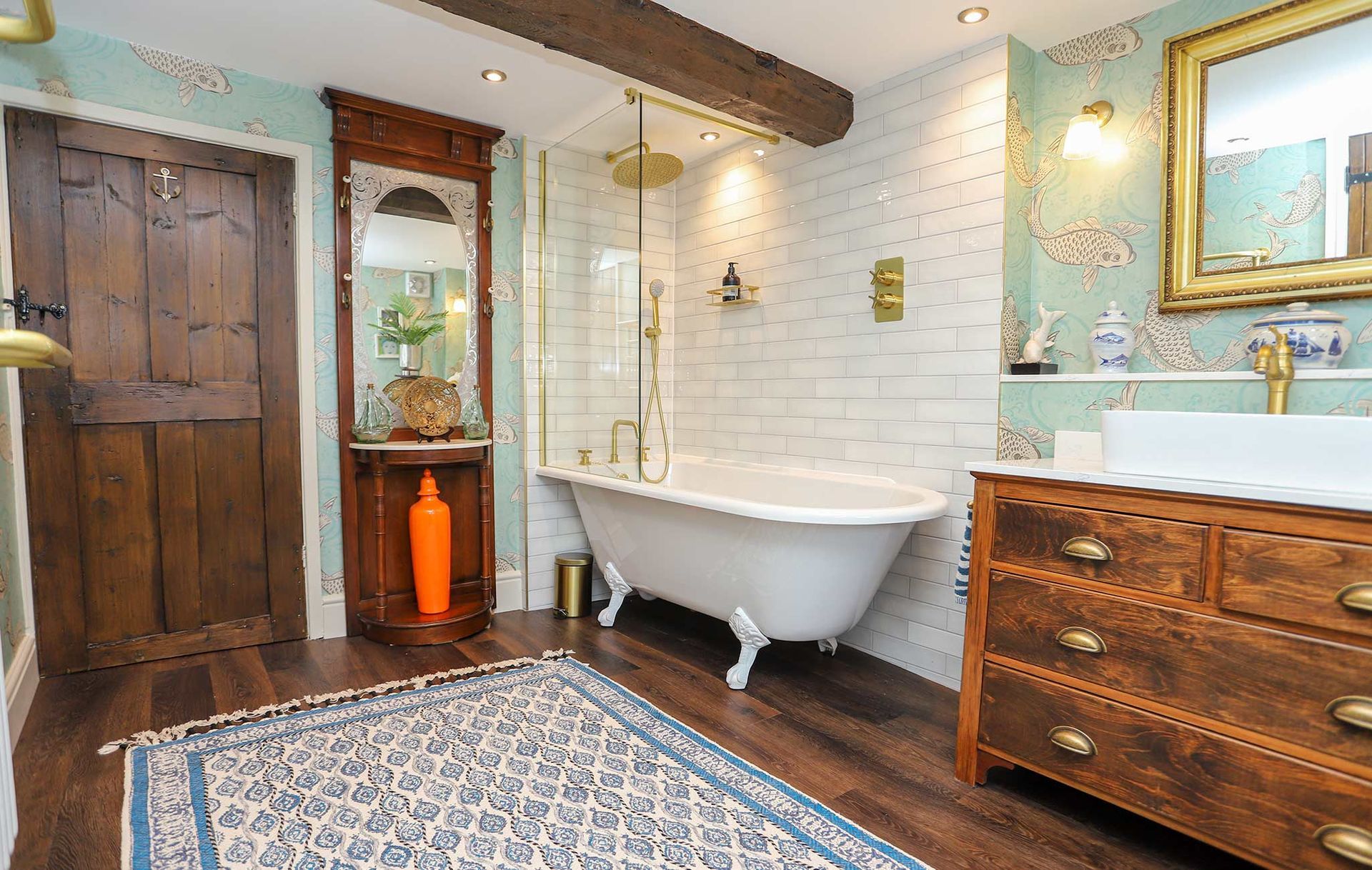 A bathroom with a bathtub and a dresser