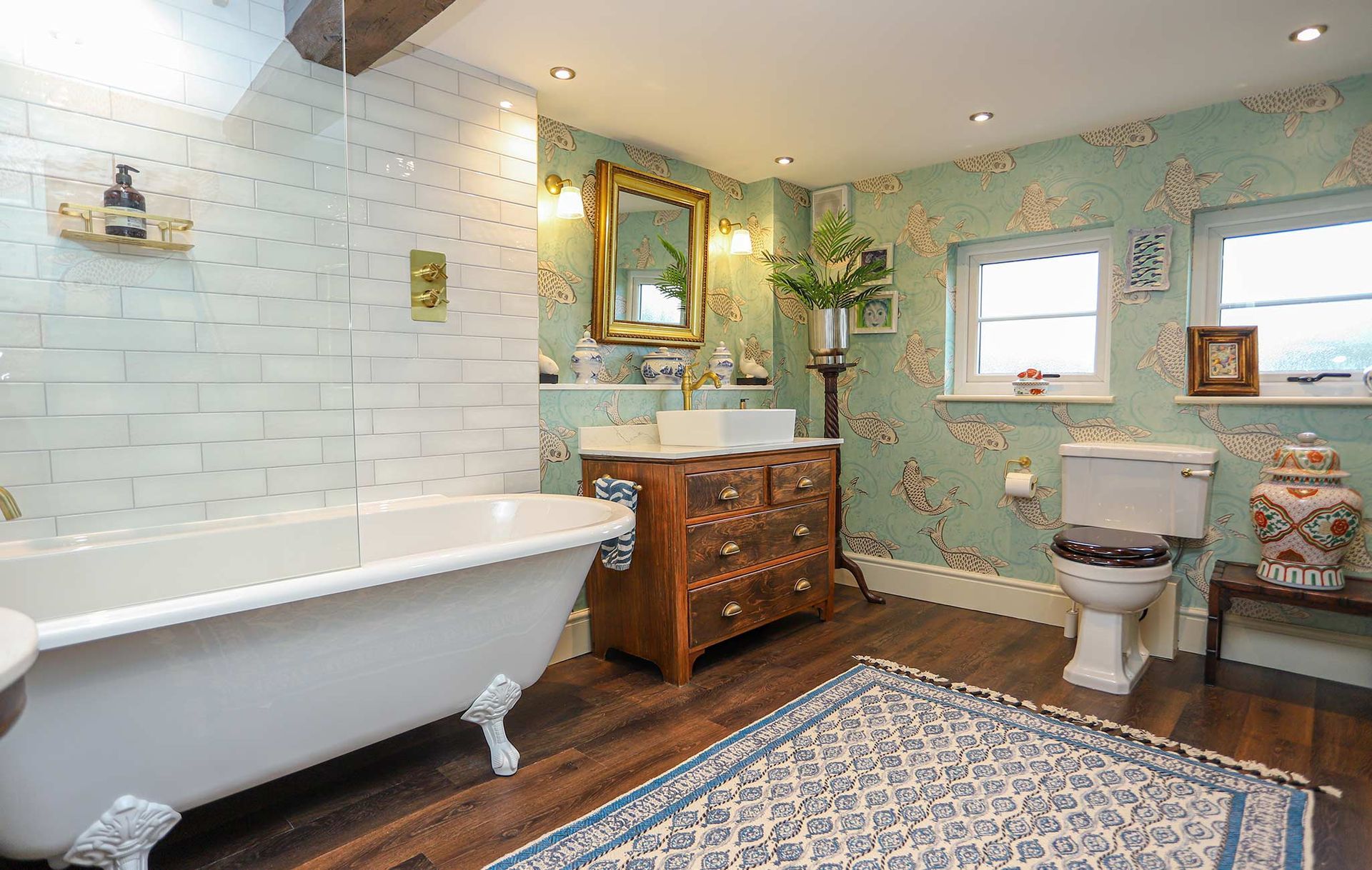 A bathroom with a claw foot tub and a toilet