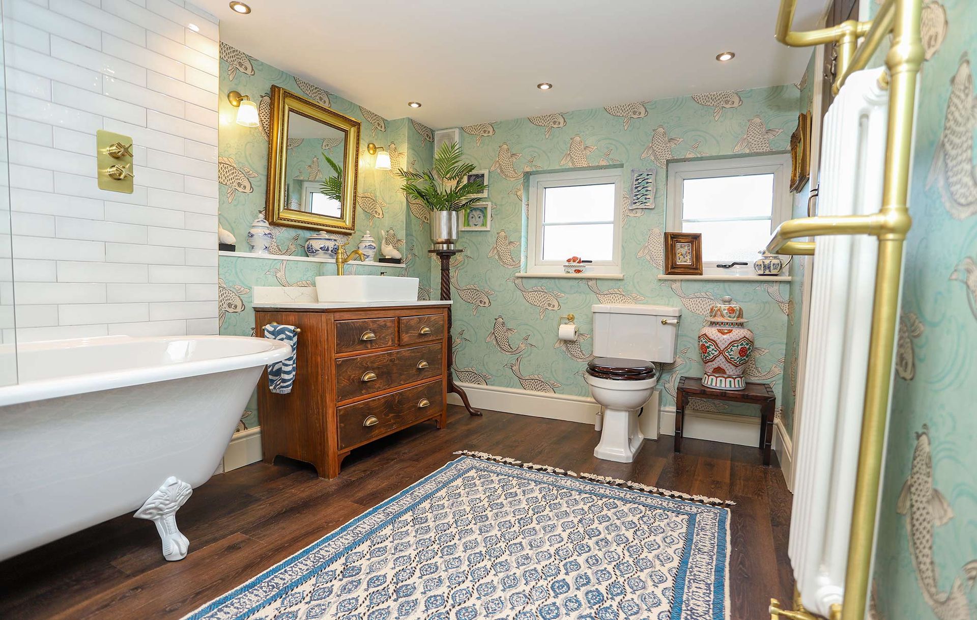A bathroom with a claw foot tub and a toilet