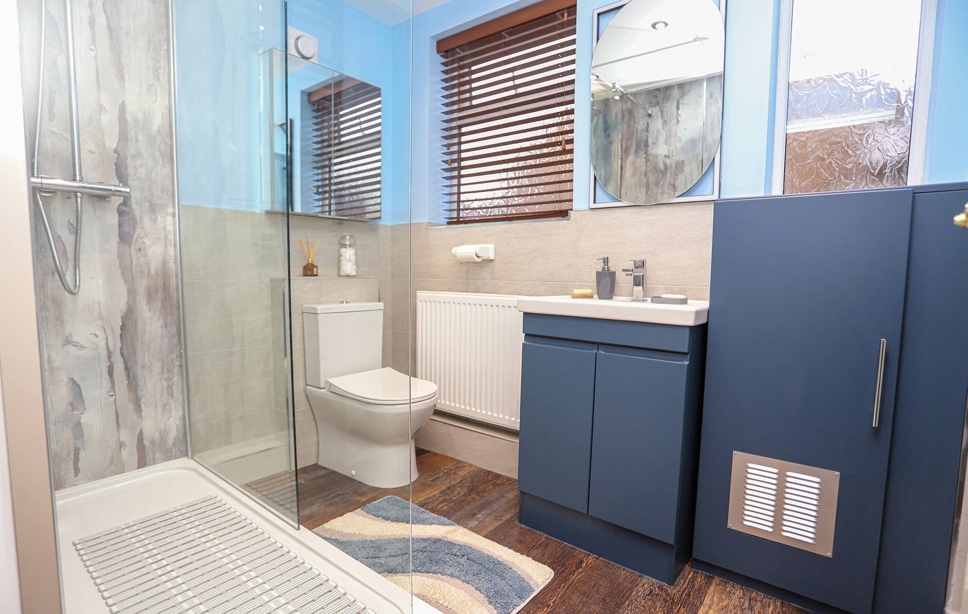 A bathroom with a toilet a sink and a mirror