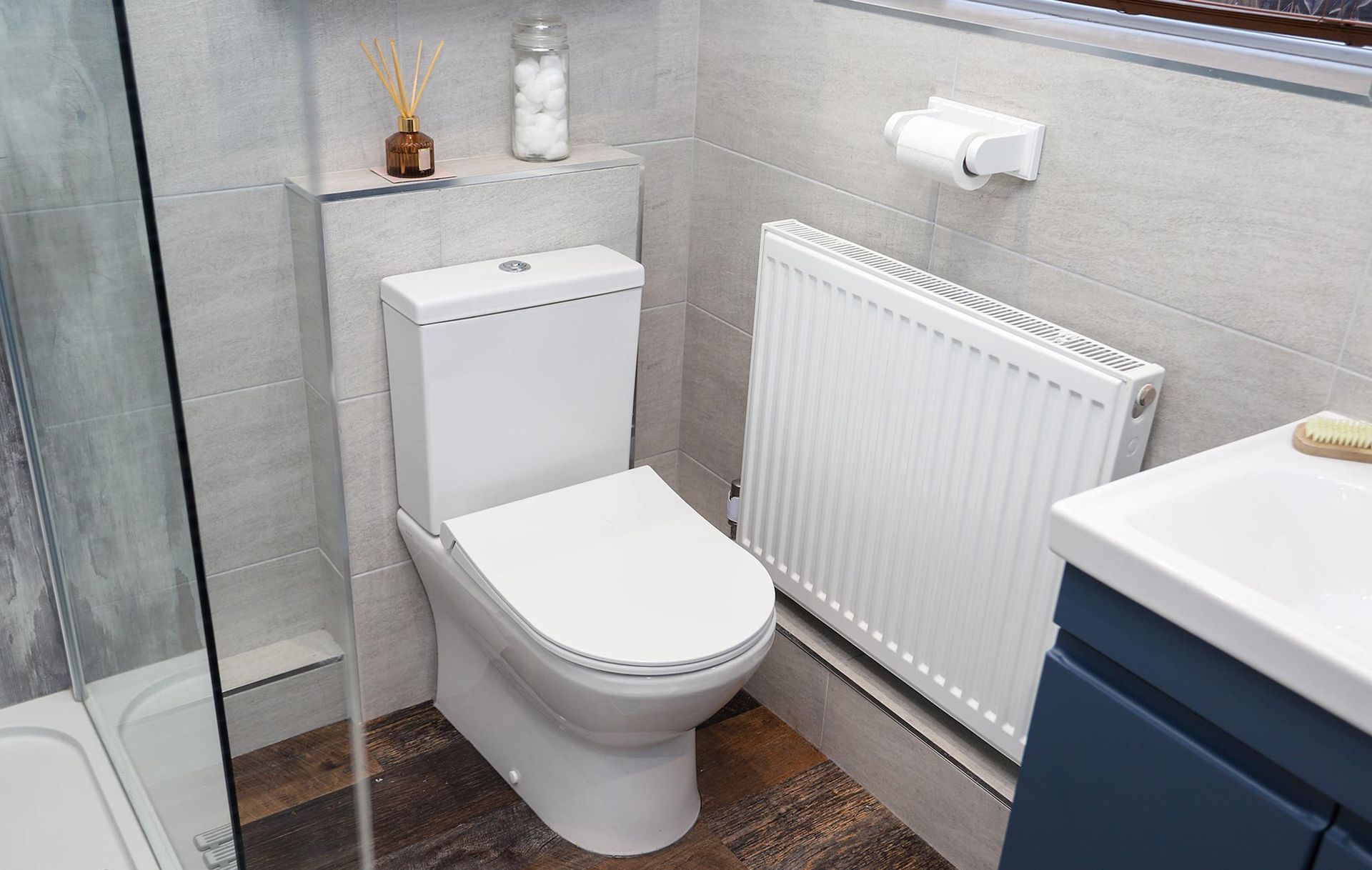 A bathroom with a toilet , sink , and shower.