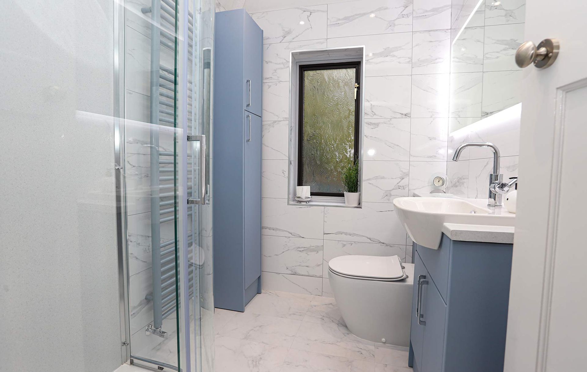 A bathroom with a toilet , sink , and shower.