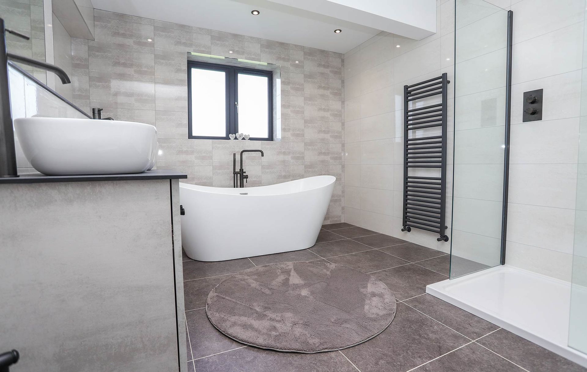 A bathroom with a bathtub , sink , and shower.