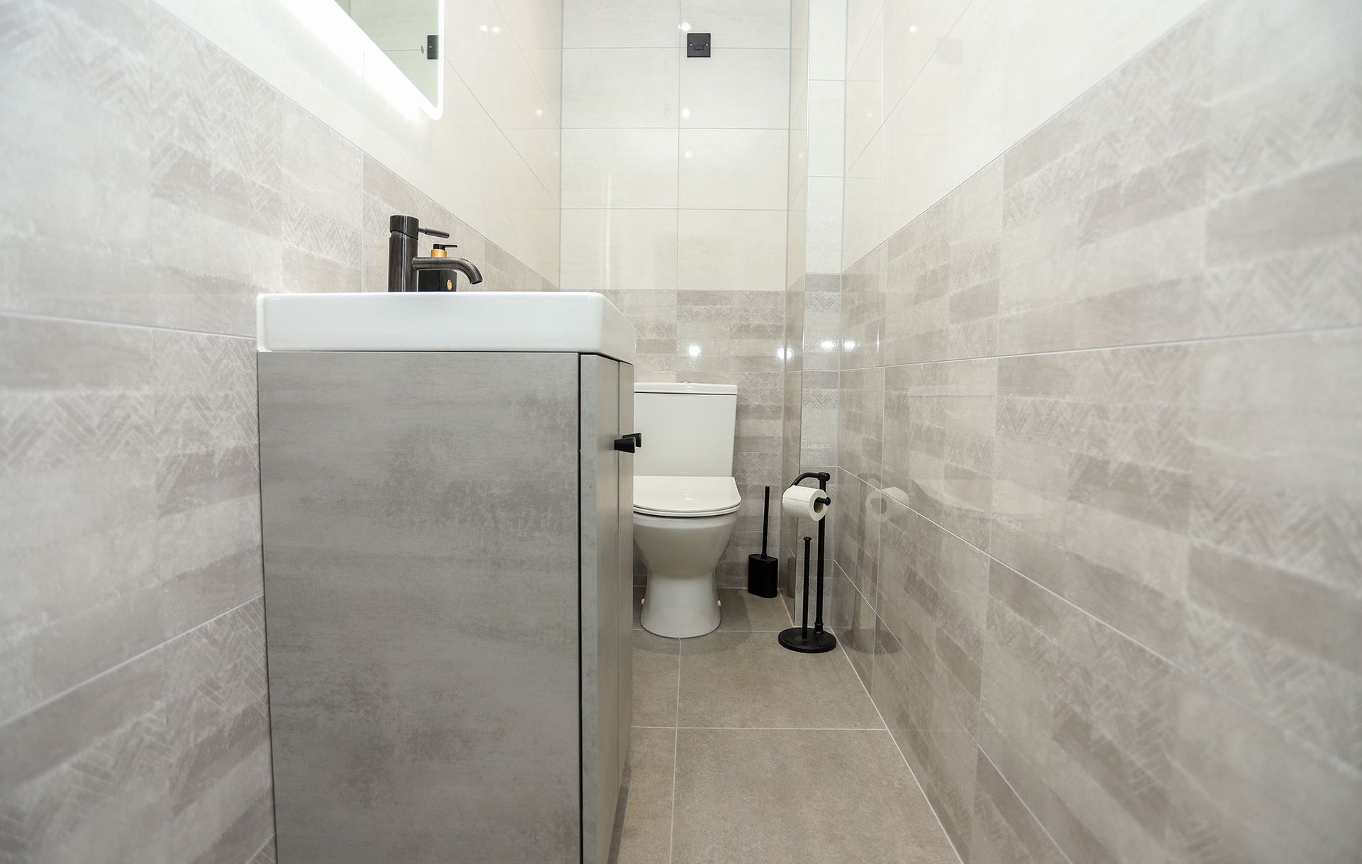 A bathroom with a toilet a sink and a mirror
