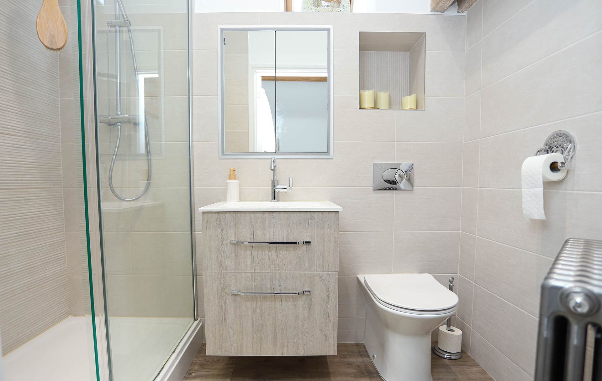 A bathroom with a toilet a sink and a walk in shower