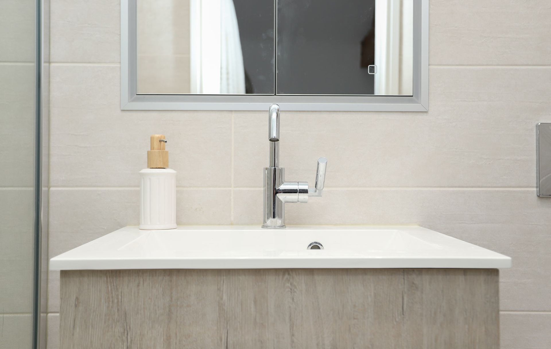 A bathroom sink with a mirror above it