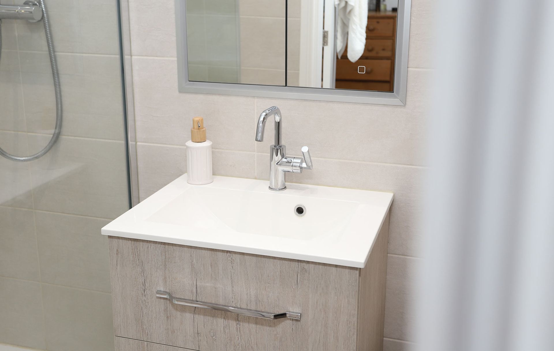 A bathroom with a sink and a mirror