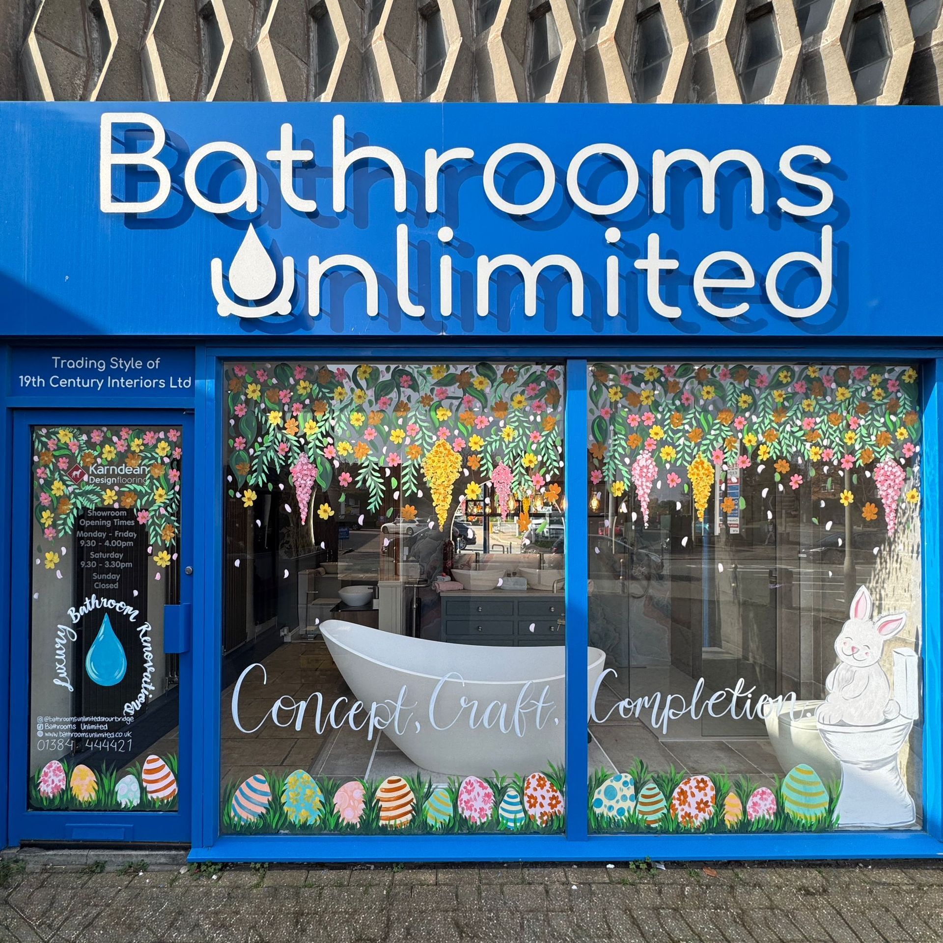 A bathrooms unlimited store front with a blue sign