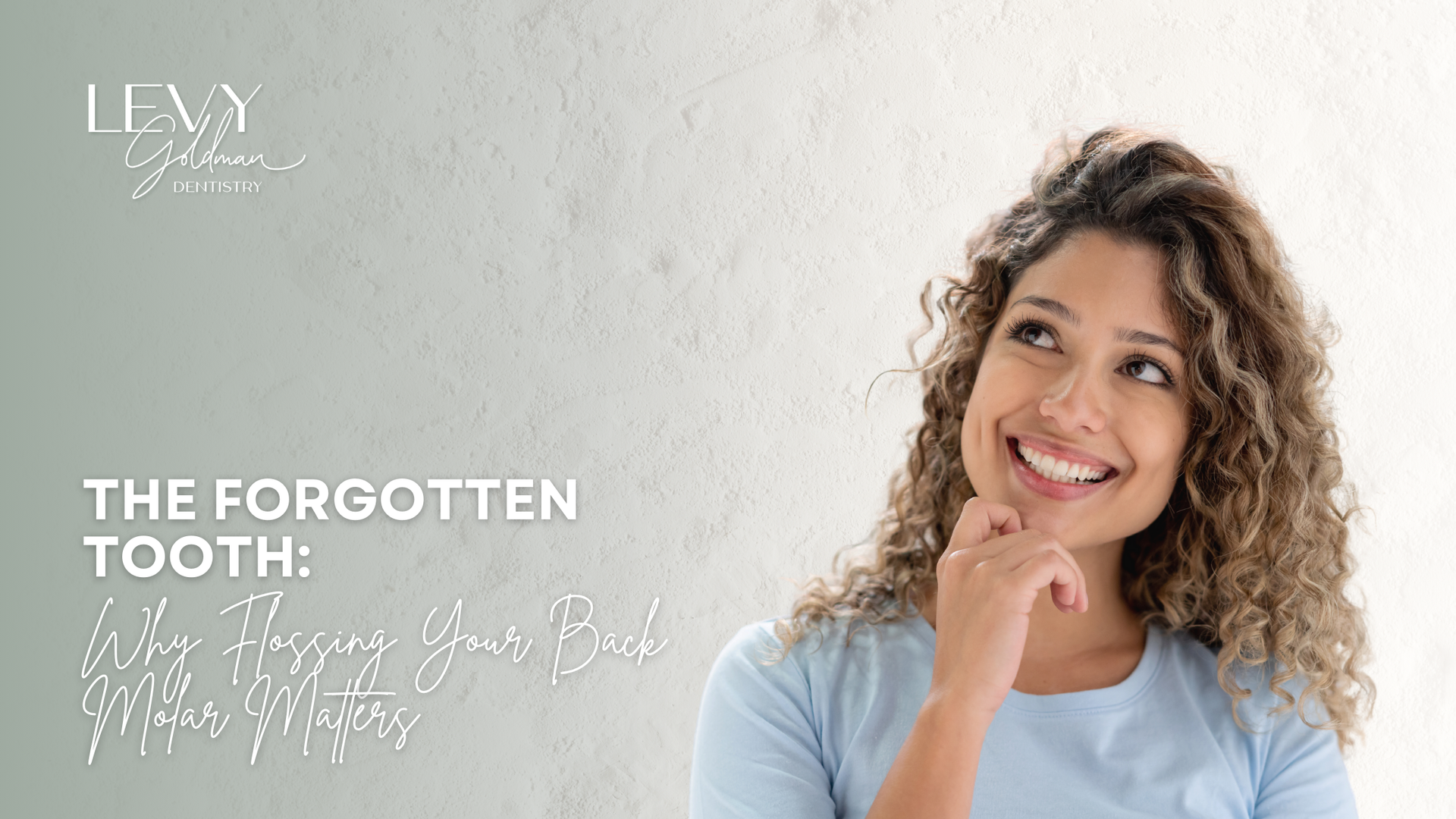Woman with curly hair looks up smiling, text: 