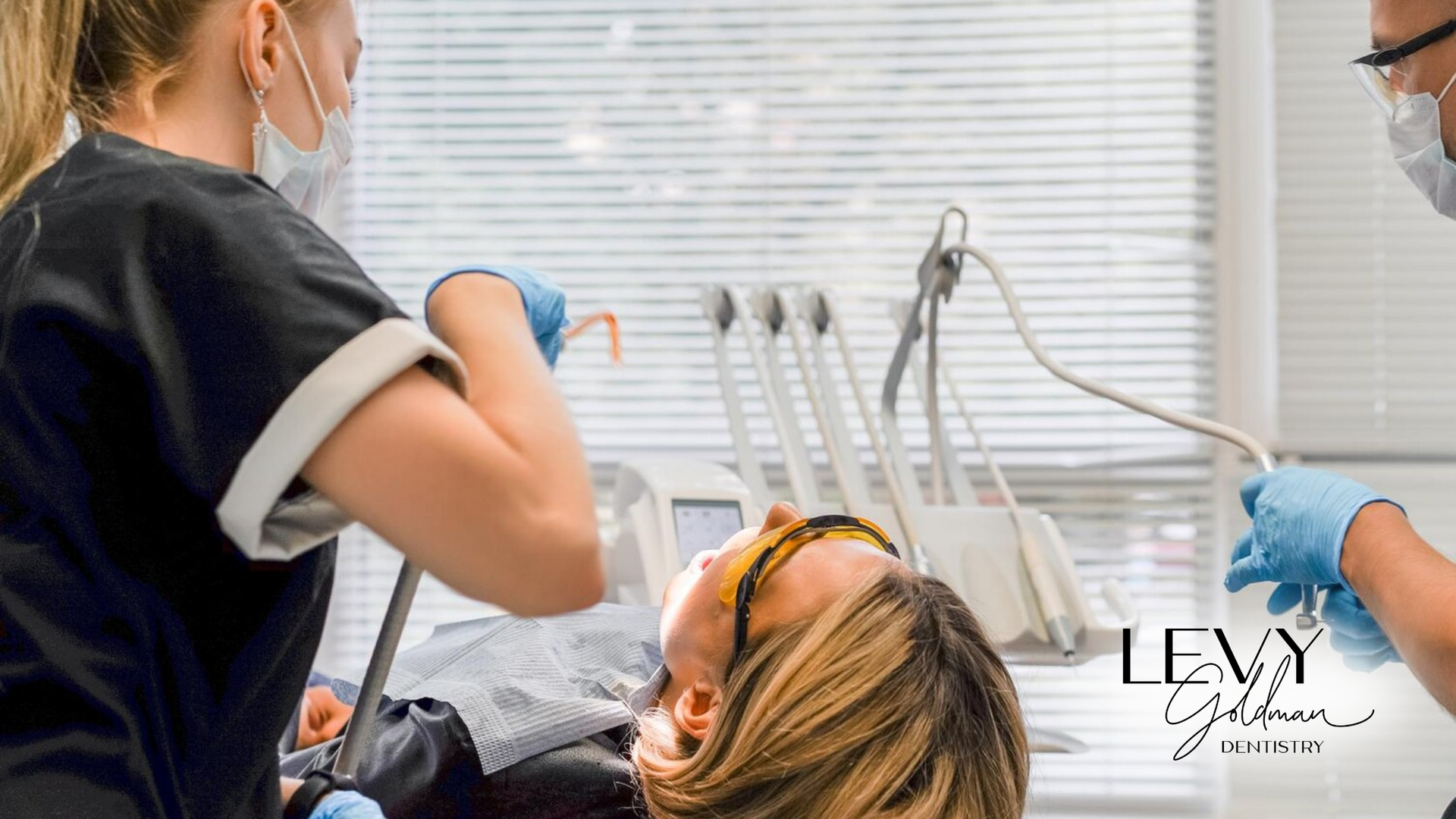 A woman is getting her teeth examined by a dentist in a dental office.