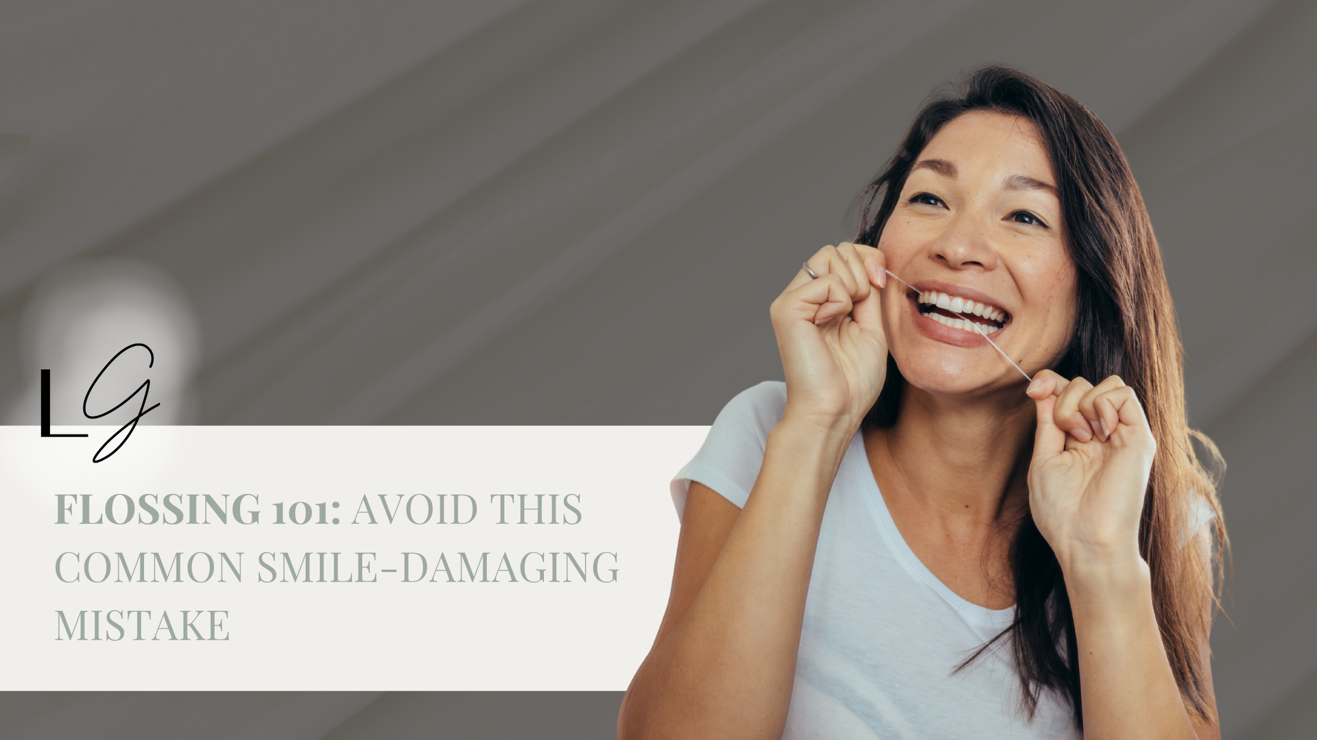 A woman is flossing her teeth and smiling.