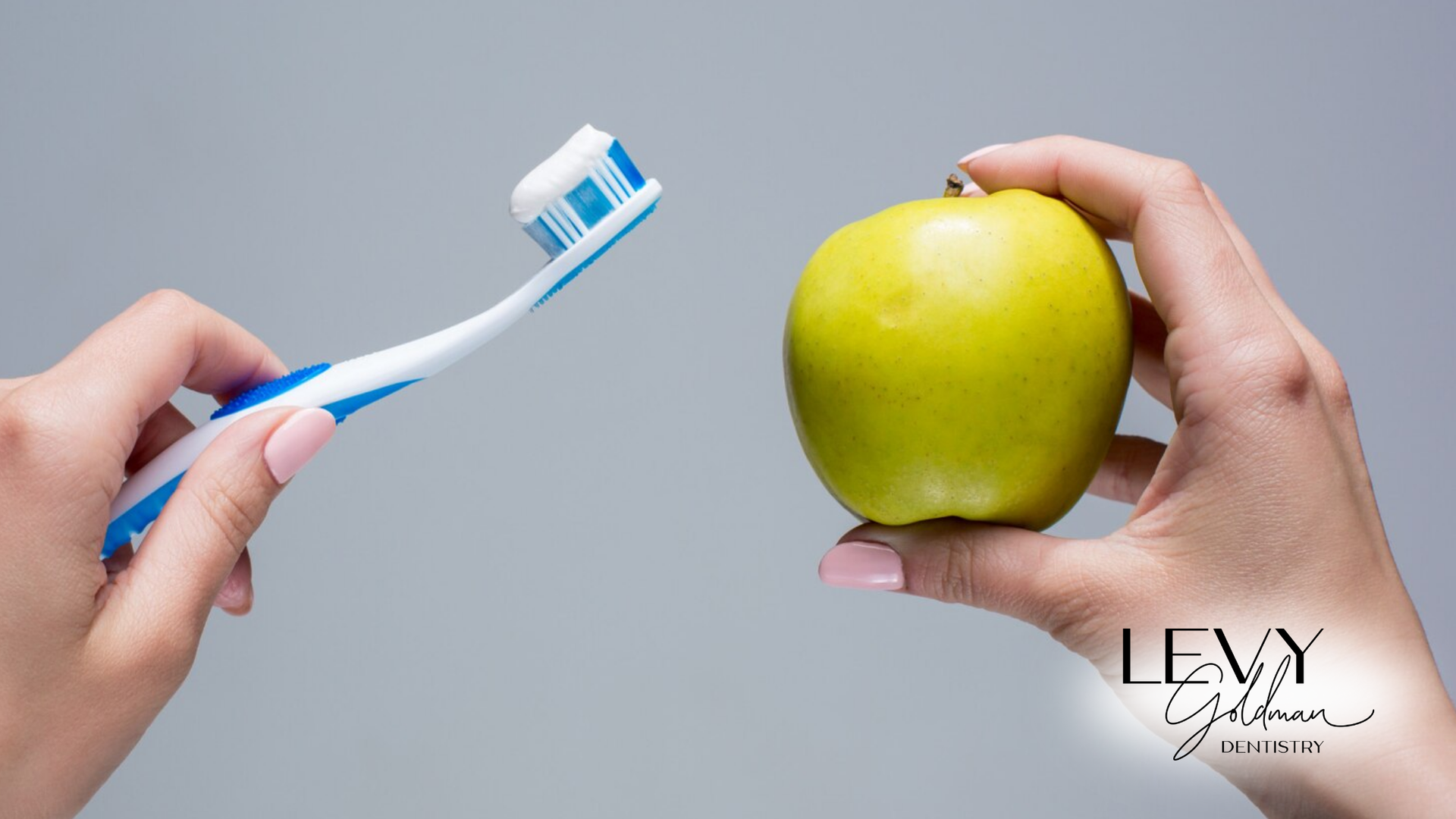 A person is brushing their teeth and holding an apple.