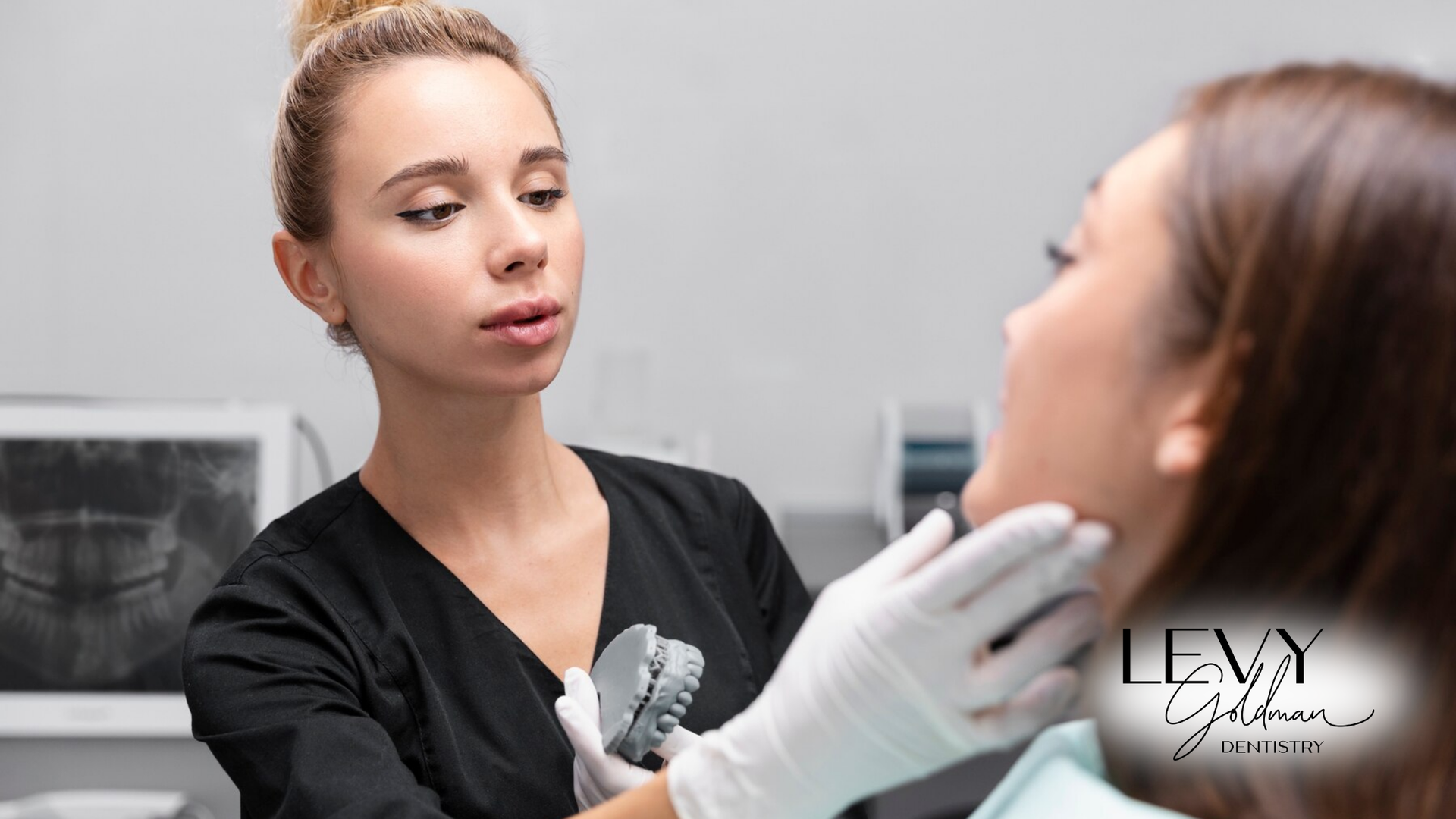 A woman is getting her teeth examined by a dentist.