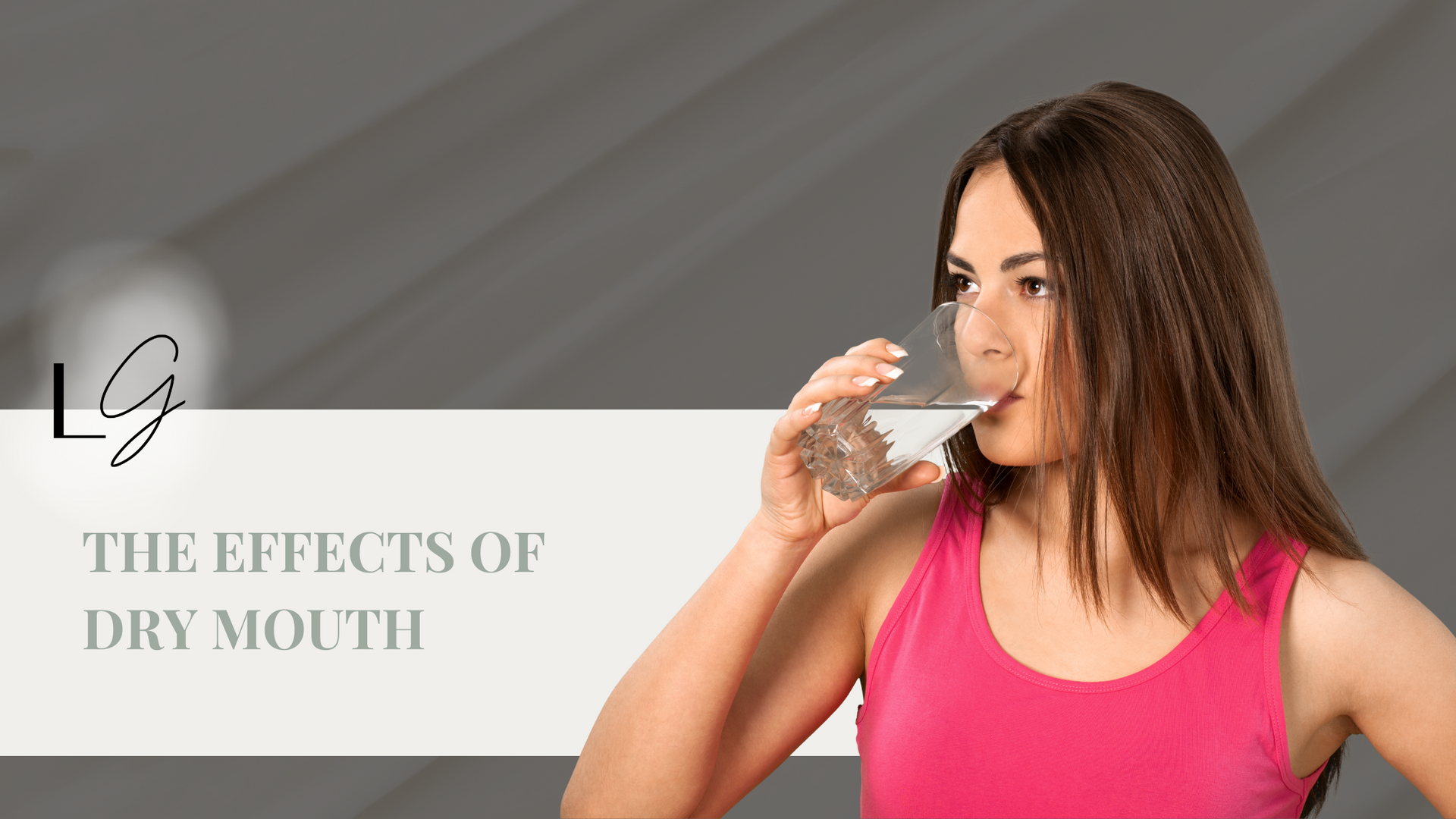 A woman is drinking water from a glass.