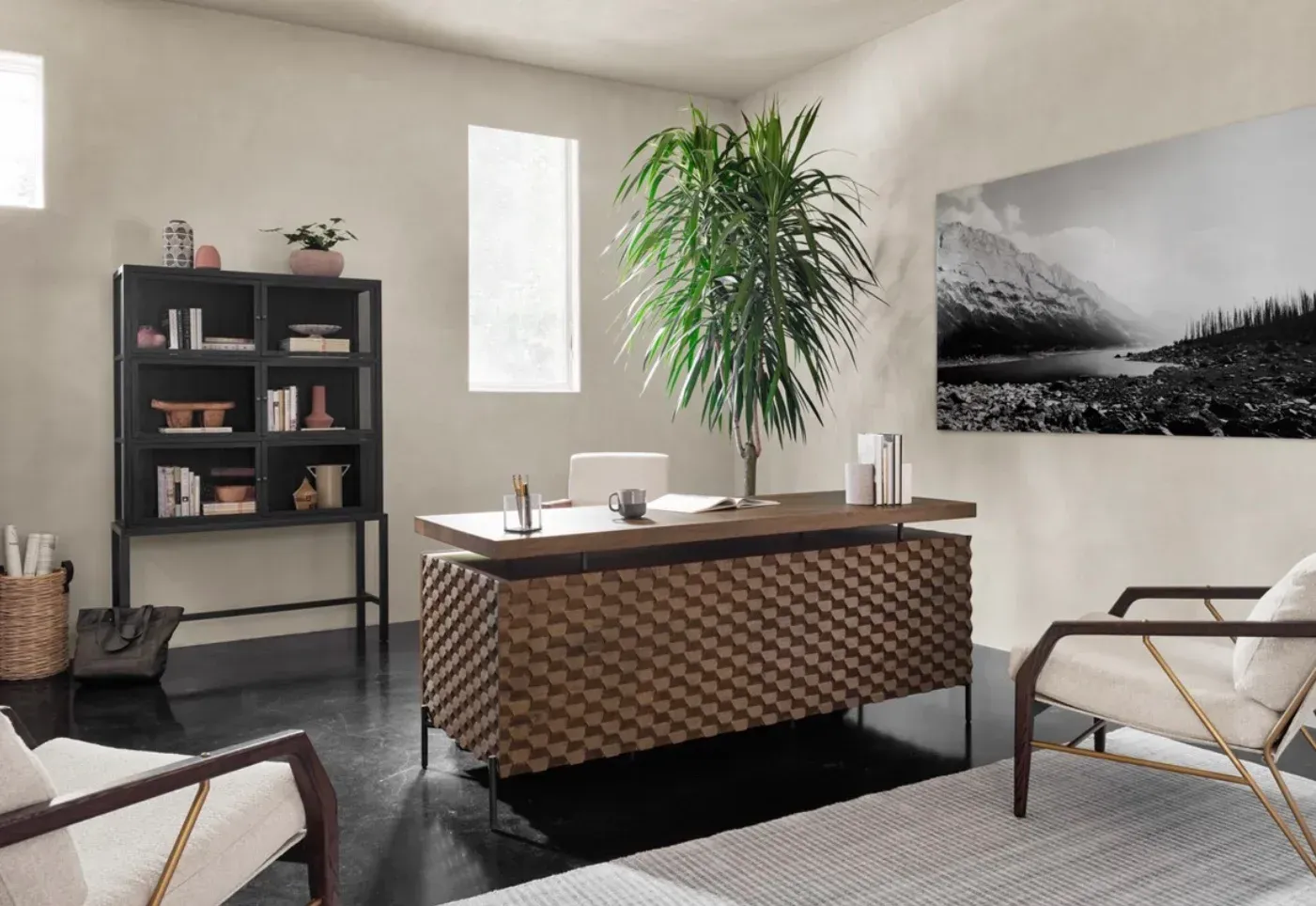 A home office with a desk , chairs , and a picture on the wall.