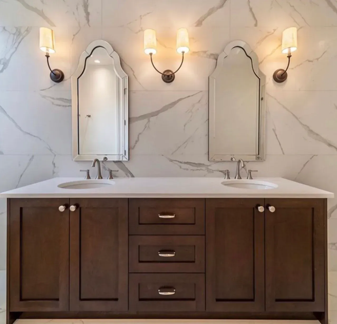 A bathroom with two sinks and two mirrors