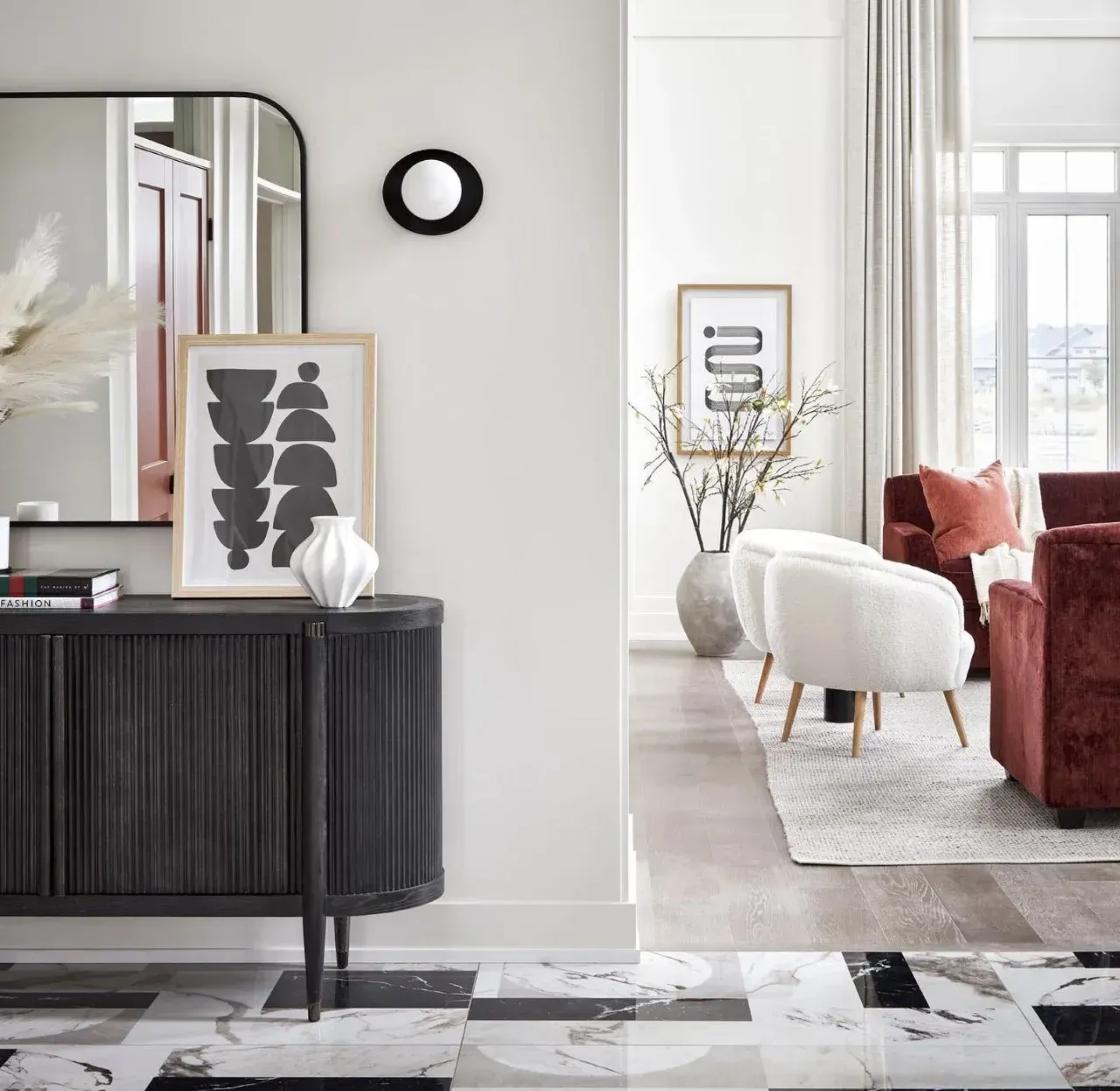 A living room with a black dresser and a mirror