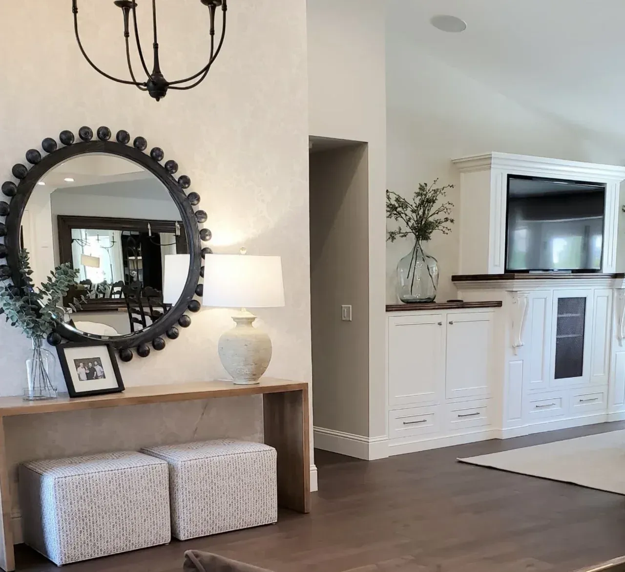 A living room with a round mirror on the wall