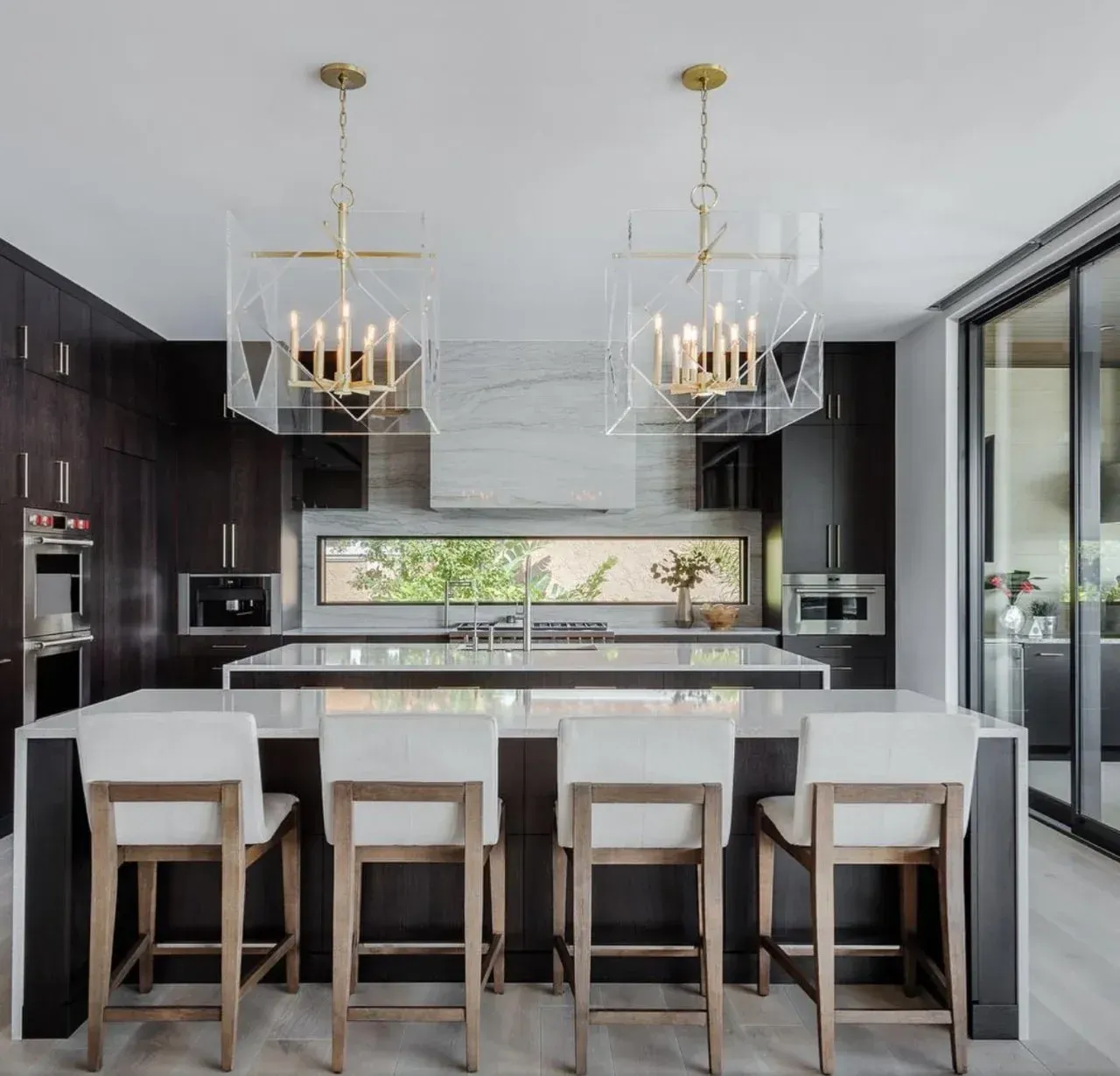 A kitchen with a large island and stools