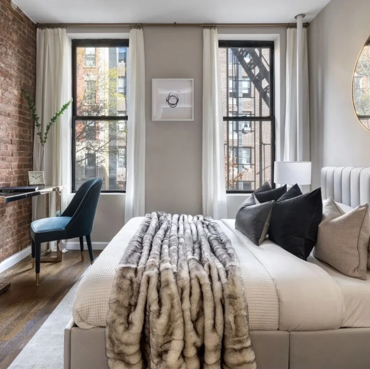 A bedroom with a fur blanket on the bed
