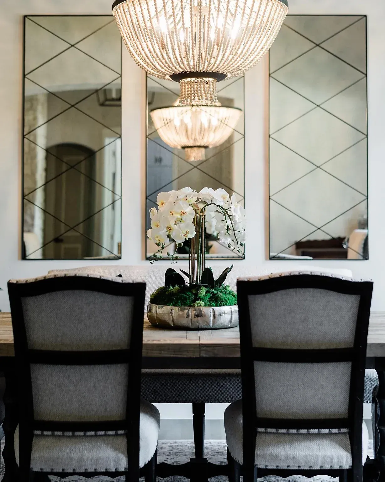 A dining room with a table and chairs and a chandelier