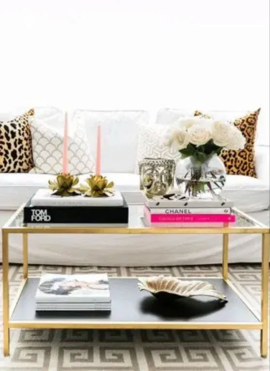 A living room with a couch and a coffee table with books on it