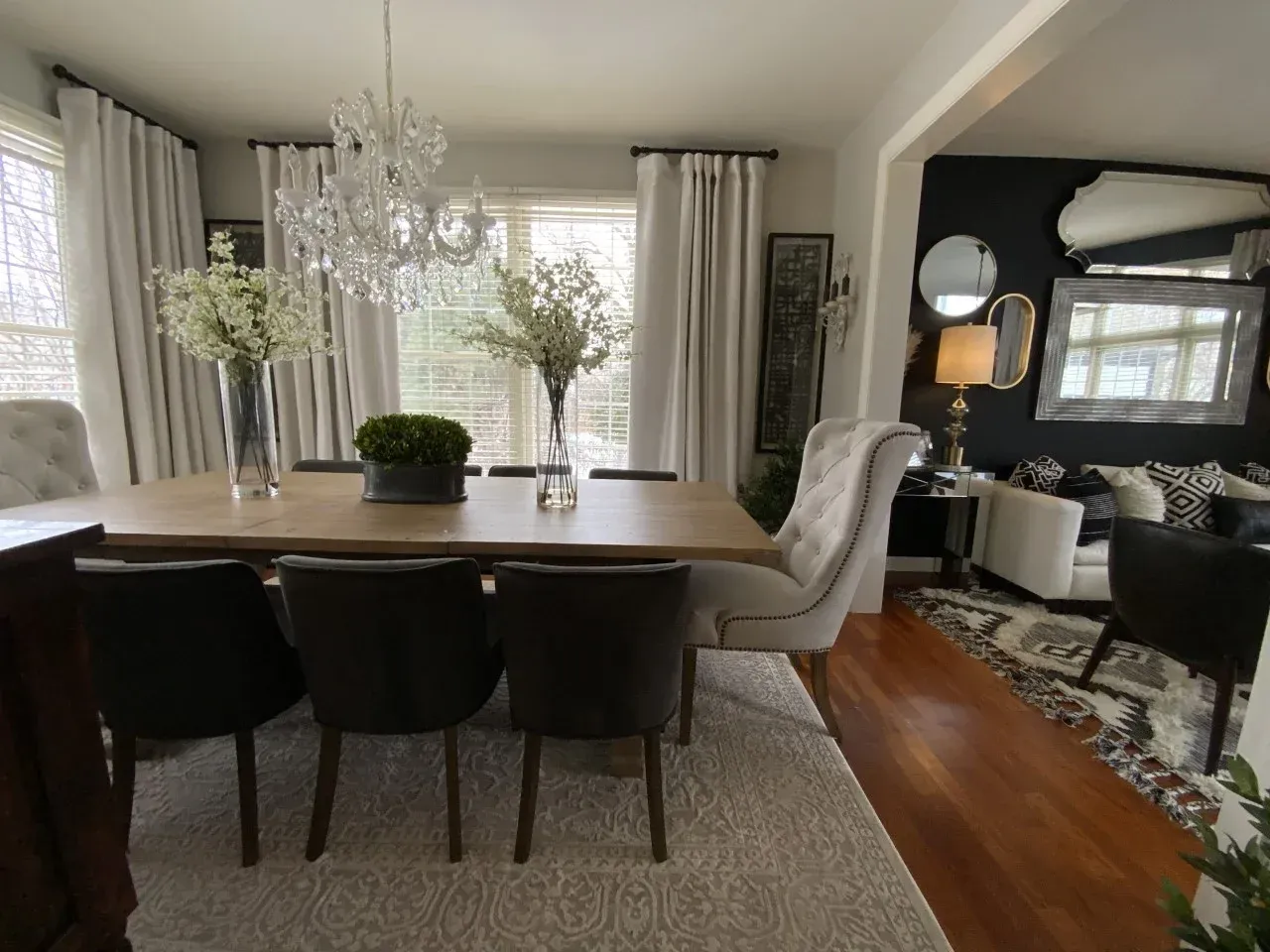 A dining room with a table and chairs and a chandelier