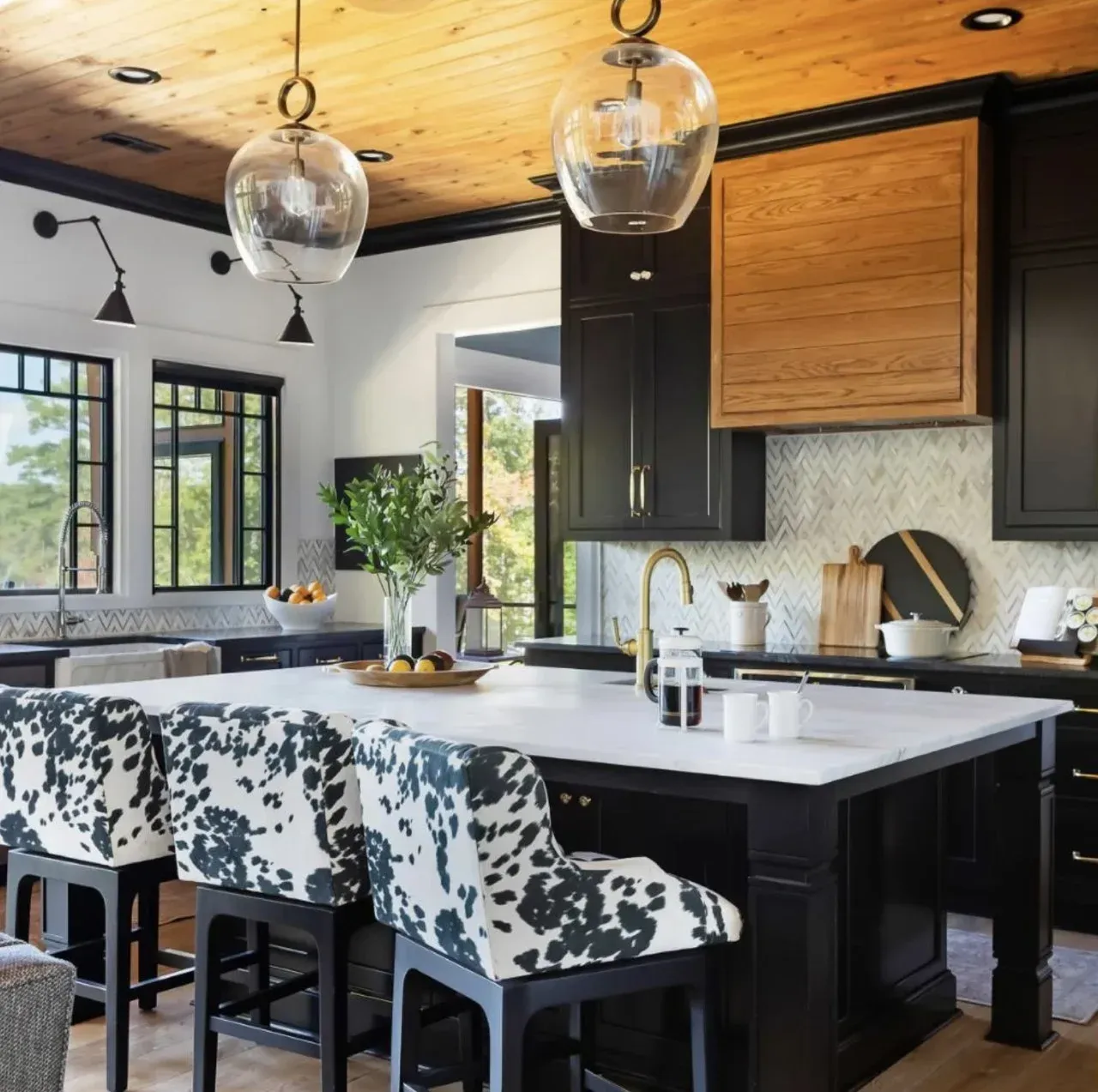 A kitchen with black cabinets and a large island