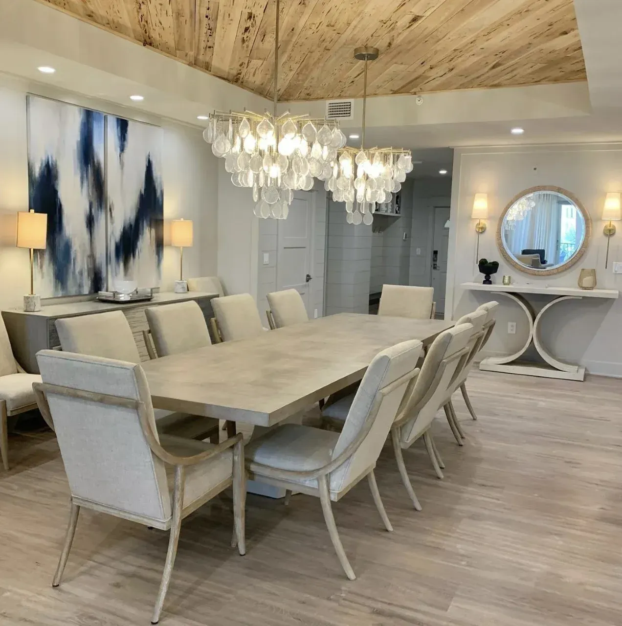 A dining room with a large table and chairs