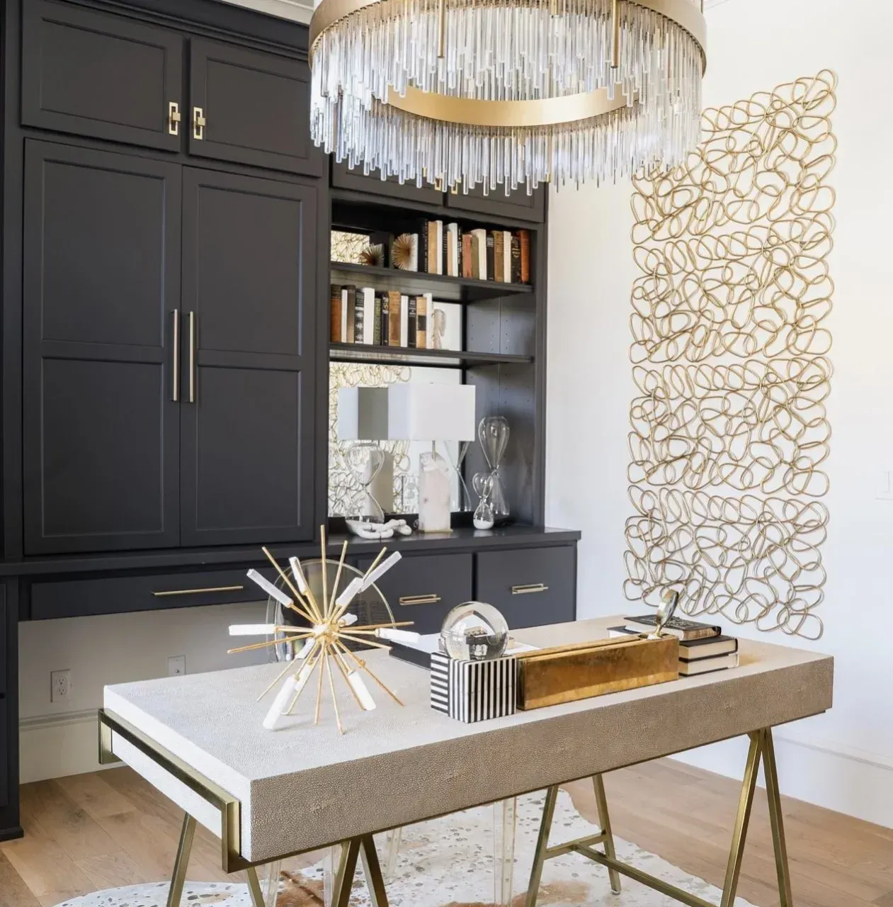 A desk in a room with a chandelier above it
