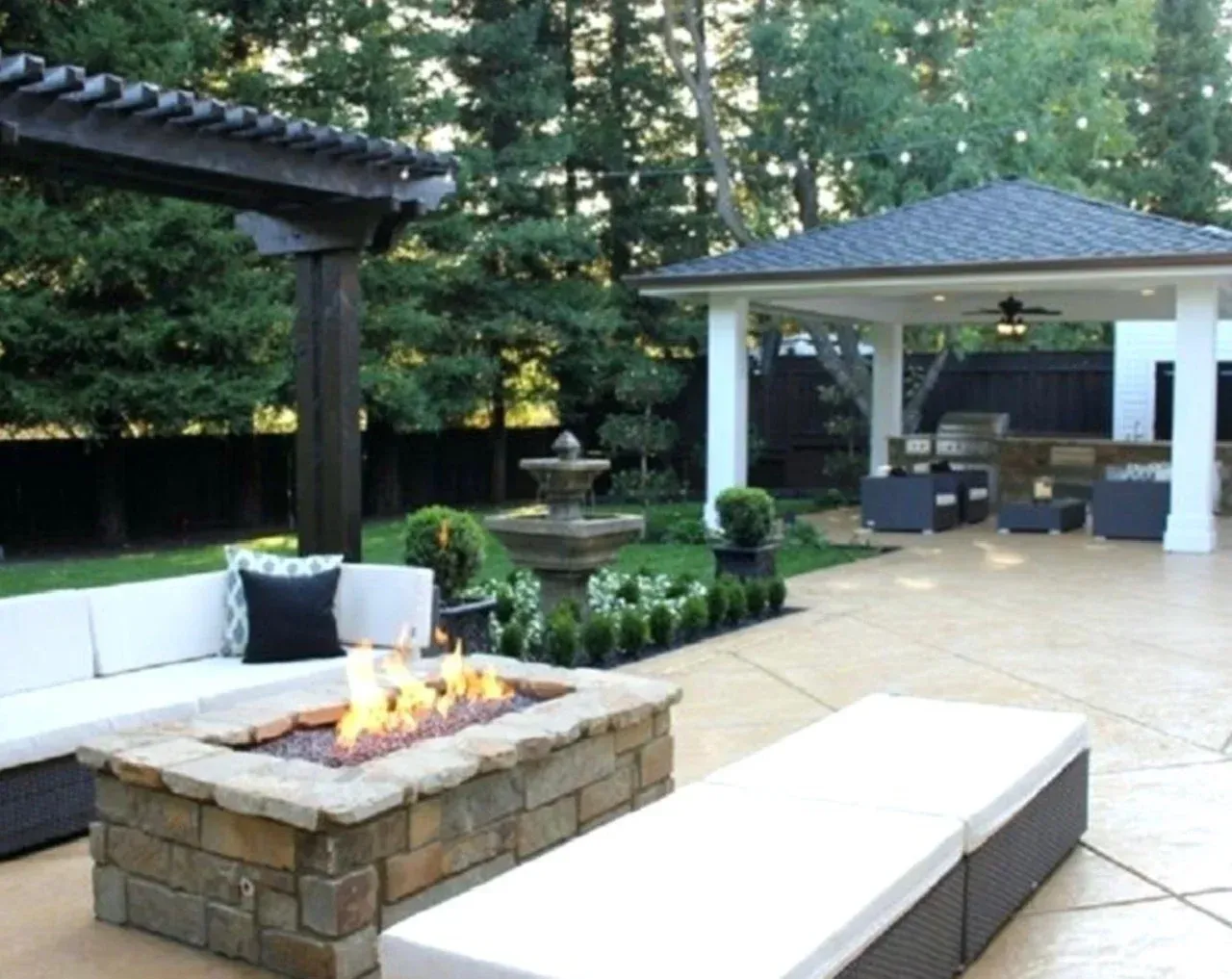 A patio with a fire pit and a gazebo