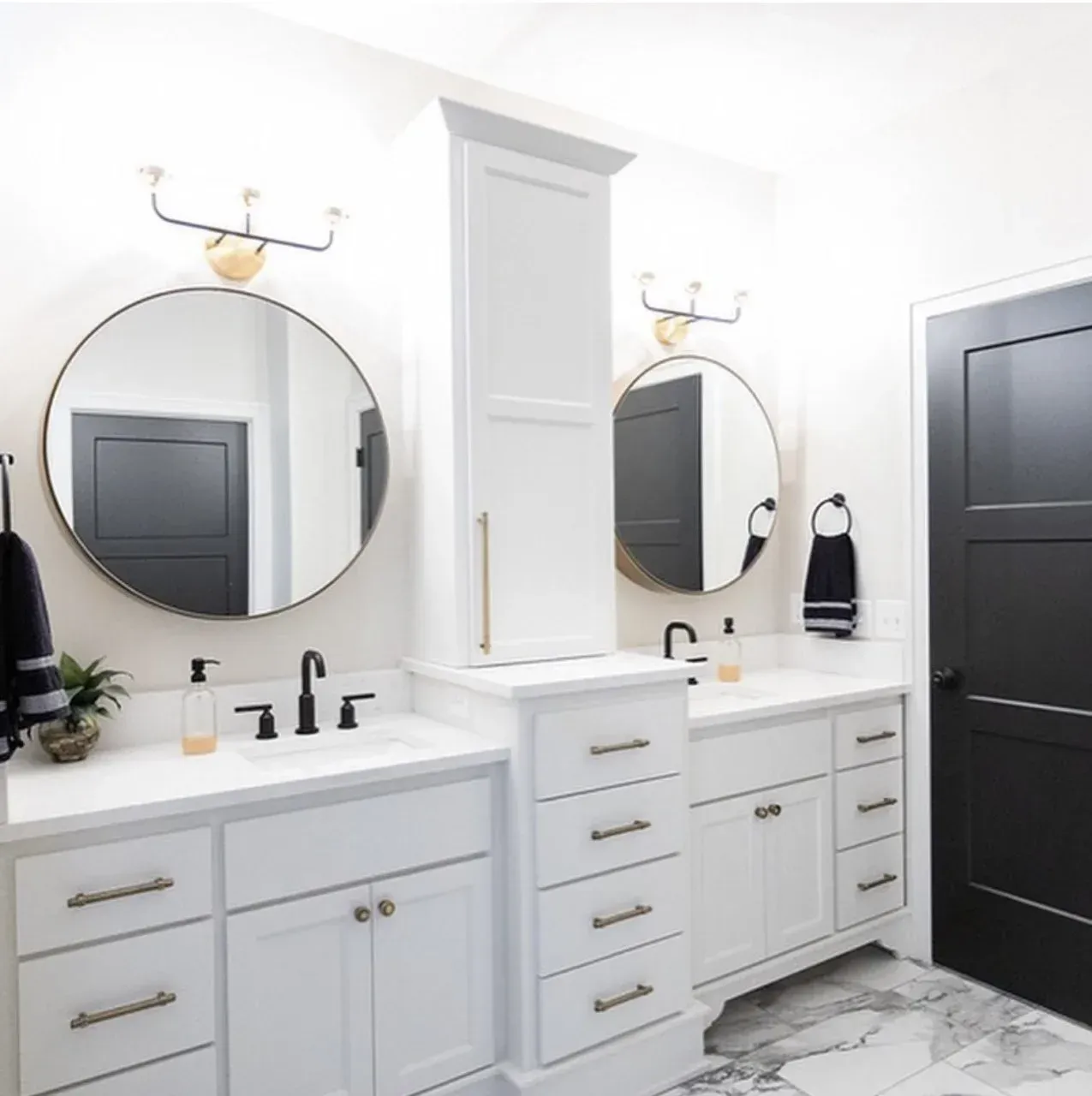 A bathroom with two sinks and two mirrors