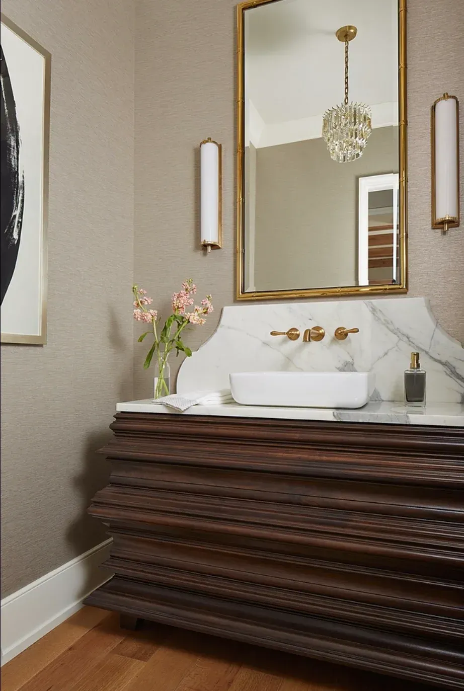A bathroom with a sink and a mirror on the wall
