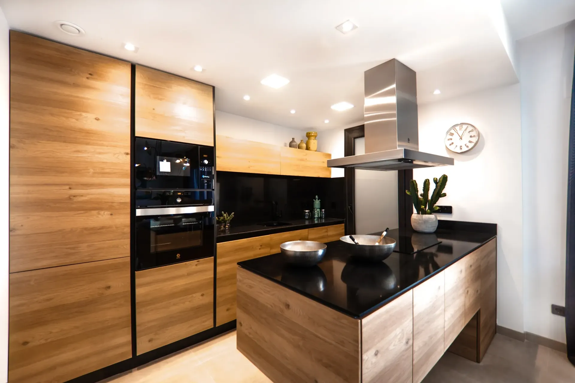 A kitchen with wooden cabinets and a black counter top