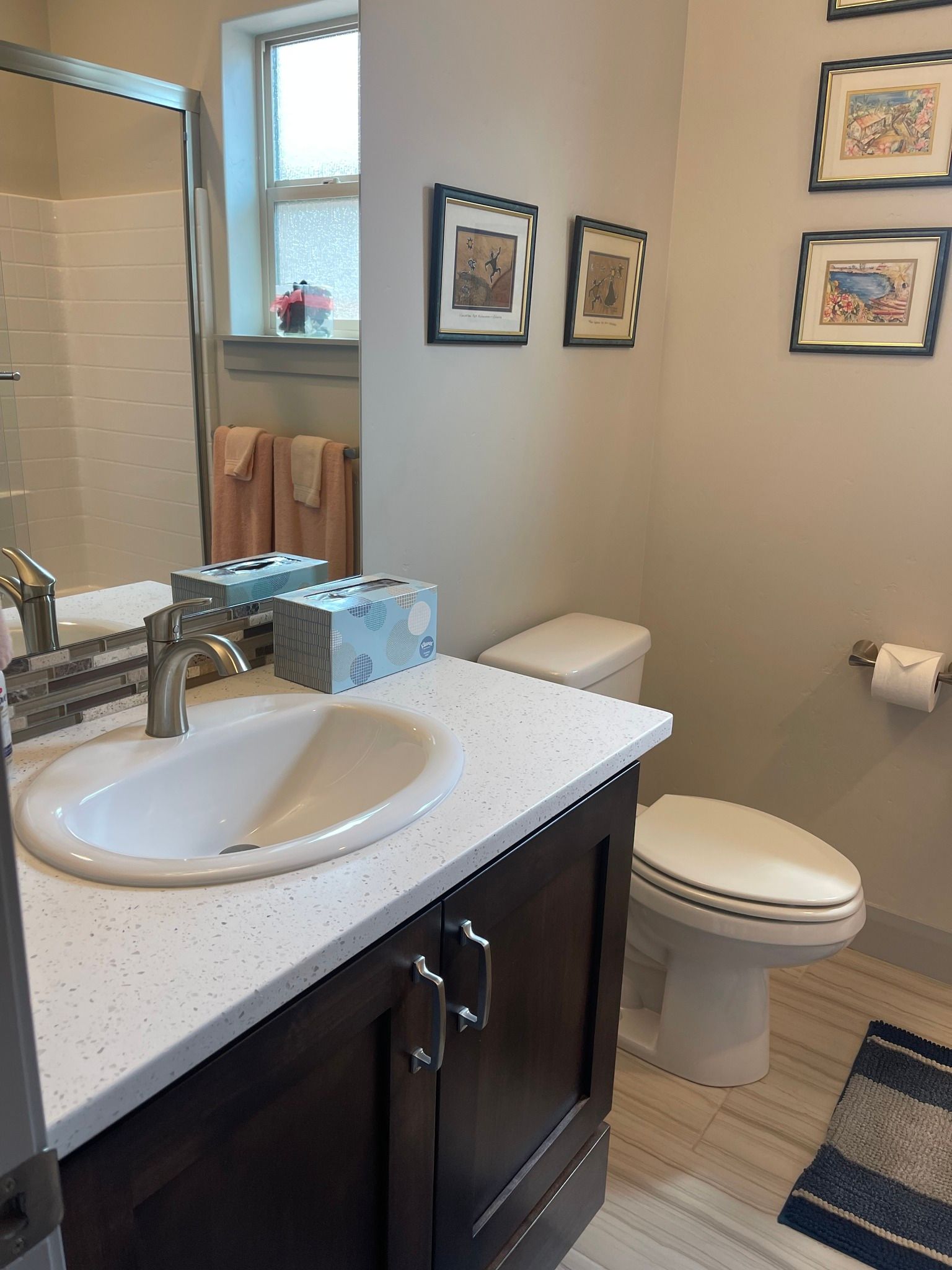 A bathroom with a sink , toilet , and mirror.