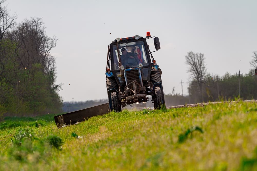 Tractor Is Driving Down A Grassy Hill - Gardener in White Hills, VIC