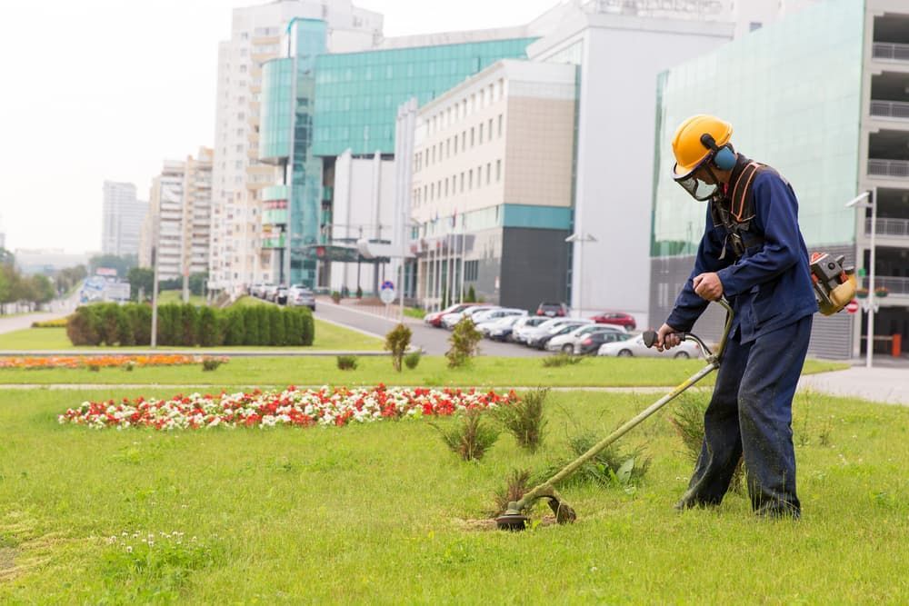 Person Wearing A Helmet And Holding A Trimmer - Gardener in Huntly, VIC