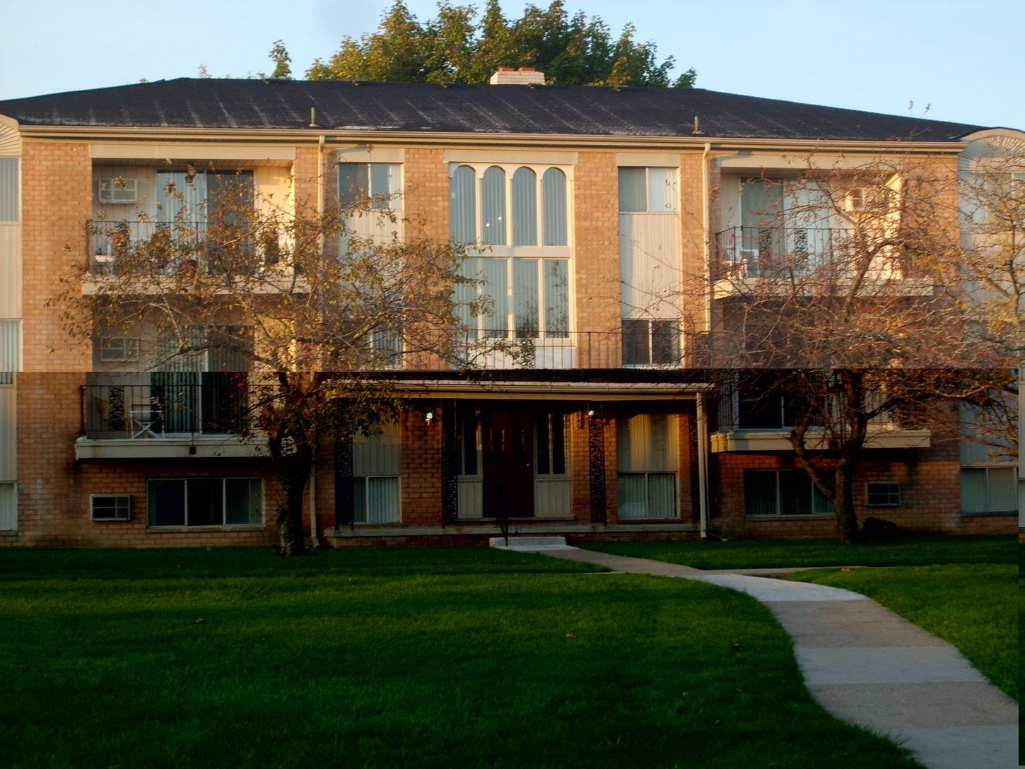 A large apartment building with a walkway leading to it
