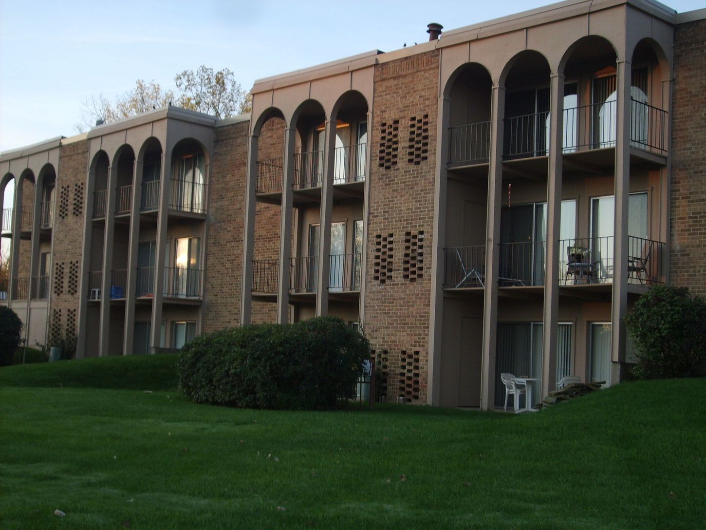 A large apartment building with arches and balconies