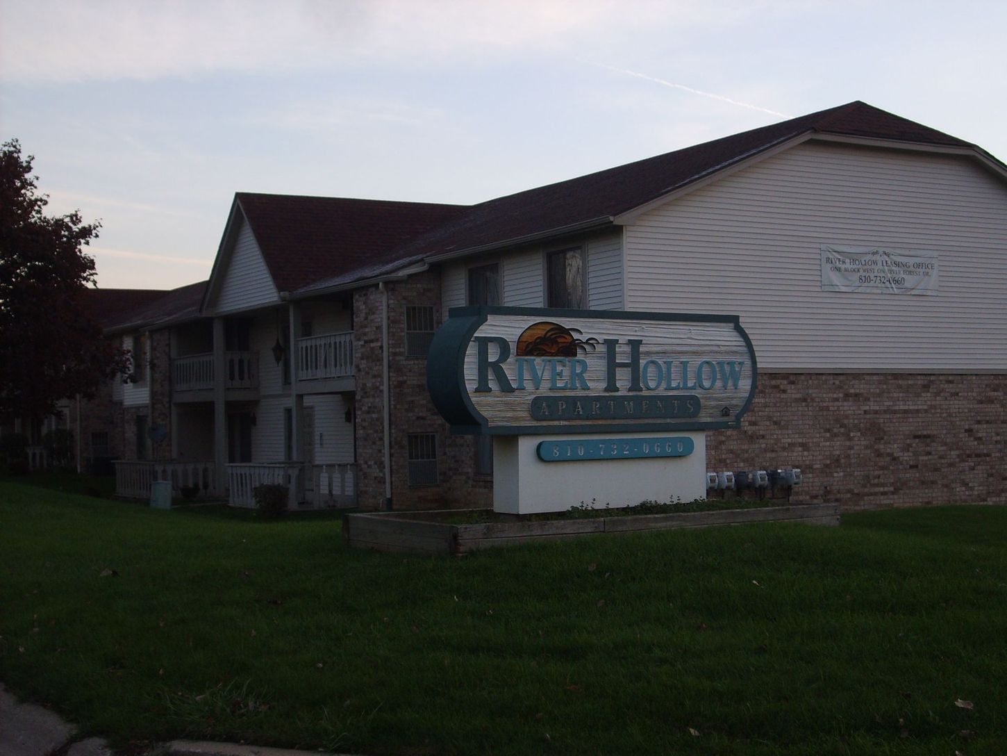 A building with a river hollow sign in front of it