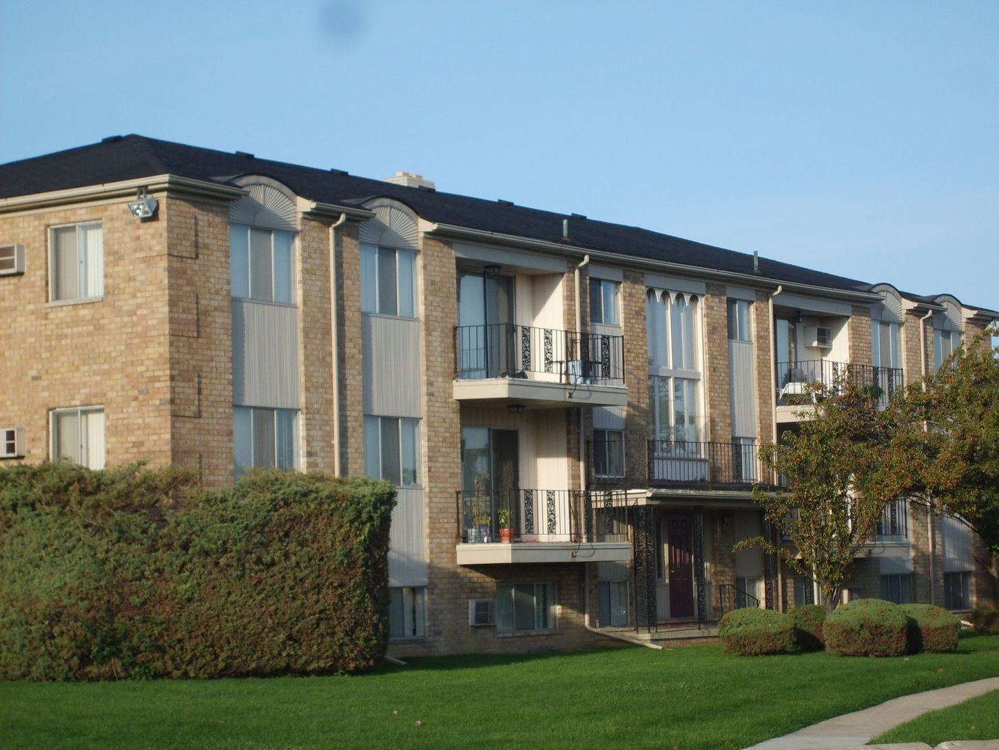 A large brick apartment building with lots of windows and balconies