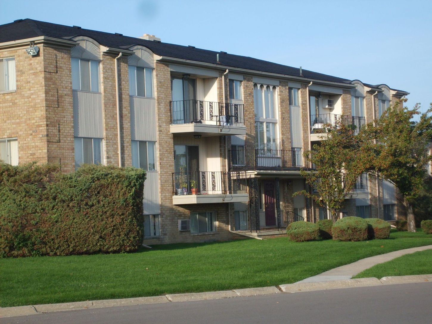 A large apartment building with a lot of windows and balconies