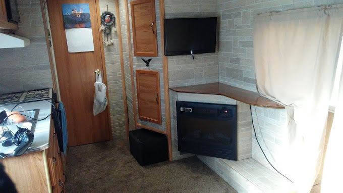 There is a fireplace in the corner of the room.