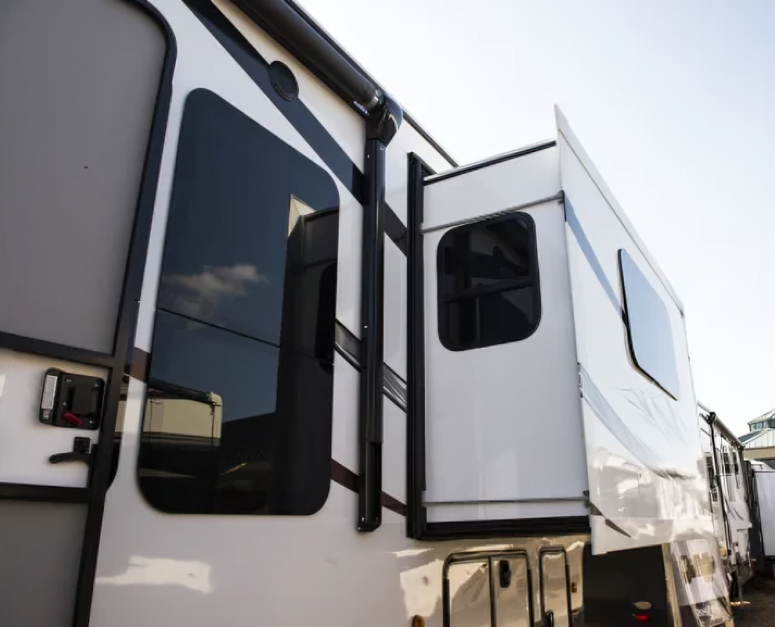 A white rv is parked in a parking lot