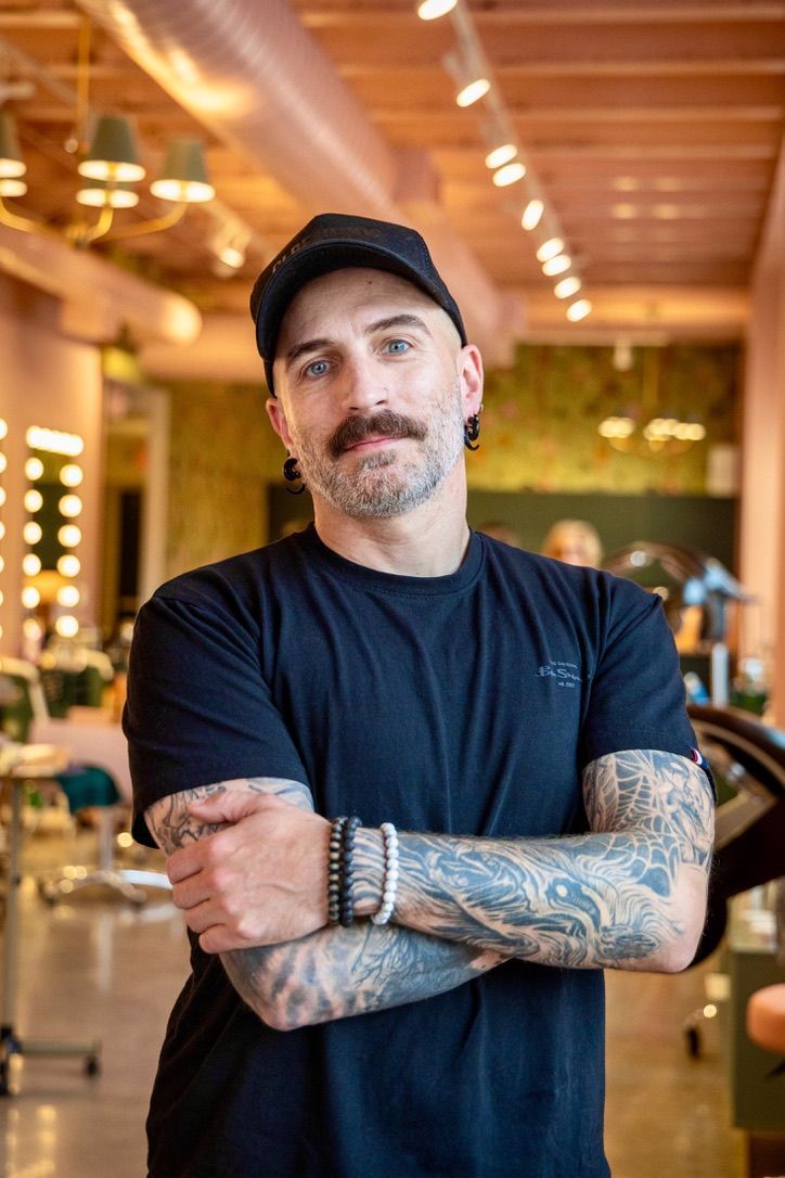 A man with a beard is wearing a grey vans sweatshirt