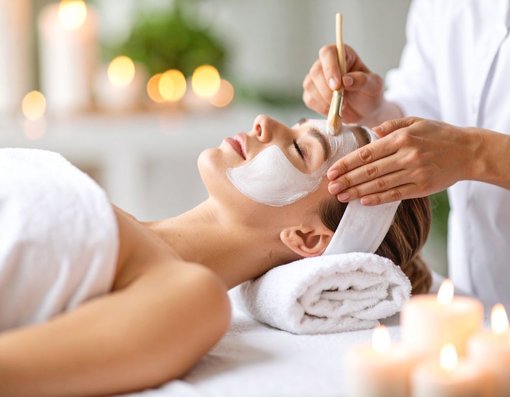 A woman is getting a facial treatment at Luxe Salon and Spa