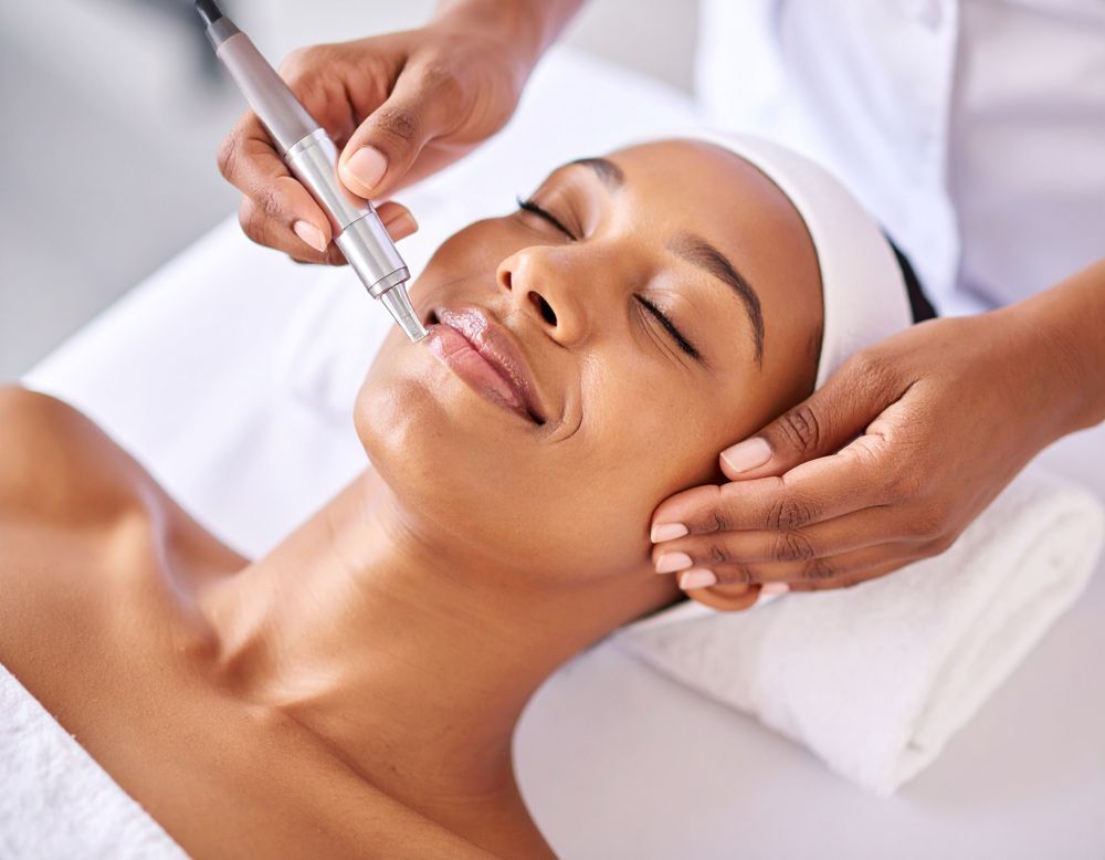 A woman is getting a facial treatment at Luxe Salon and Spa
